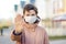 Woman in medical face mask showing gesture Stop - keep social distance while coronavirus epidemic. Focus on face. For safety  stay