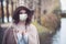 Woman in medical face mask walking in park
