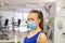 Woman with medical facemask in gym after indoor training. Female breathes deeply stock photo