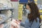 Woman in medical mask choosing goods in a store. Concept of shopping during quarantine at covid-19 pandemic. shopping at the time