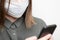 Woman in medical mask. Disposable device. Lady chatting on smartphone. Preventive gear protective against viruses and diseases.