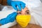 Woman in a medical mask waxing her eyebrow, up close. Woman in a beauty parlor. Plastic surgery clinic