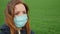 Woman in medical protective mask outdoors