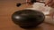 Woman meditates doing yoga playing on the steel tongue drum. Close-up.