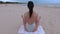 Woman meditates by the sea