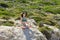 Woman meditating in Lotus pose on the cliffs of the beautiful beach of Balos, Greece. the concept of rest, relaxation, spiritual p