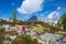 Woman meditating in natural environment on the mountains. One person sitting on rock in lotus pose in beautiful alpine ambient