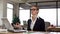 Woman meditating at office desk, reducing work stress and irritation, relaxing