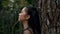 A Woman meditating with peace in the forest