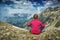 Woman meditating on the rocky hill