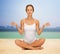Woman meditating in yoga lotus pose