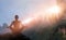 Woman meditating yoga at sunset mountains with nature. Outdoor s