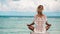 Woman meditation in a yoga pose at the beach