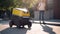 Woman meet delivery robot on street sidewalk, last mile secure package delivery via robot