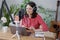 woman with microphone headphones records podcast in home office or recording studio