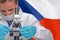 Woman with a microscope against Czech Republic flag background. Medical technology and pharmaceutical research in Czech Republic