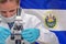Woman with a microscope against El Salvador flag background. Medical technology and pharmaceutical research in El Salvador