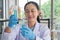 Woman middle-age Asian scientists in laboratory. expert, are working test tube make research.