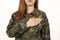 Woman in military camouflage standinwith her hand on her heart