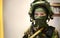 Woman in military clothes with mask over light background and with vignetting. Female soldier in camouflage Woman at war concept.