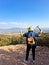 Woman with miner\\\'s pick hammer works as a geologist, studies the structure of the mineral soil of the mountain