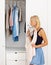 Woman, mirror or choosing clothes in closet for morning routine, fashion or clothing in bedroom of home. Person, outfit