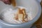 A woman mixes butter, sugar and flour in a bowl. Levington cake, stages of preparation