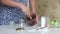 A woman mixes nut butter in a blender bowl. Walnut urbech. The ingredients are on the table side by side