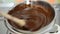 Woman mixing chocolate and butter in a bain marie pot