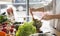 Woman mixing delicious superfood salad ingredients in the kitchen