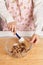 Woman mixing muffin ingredients with chocolate chips