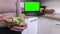 Woman mixing salads in bowl close up near laptop PC with green screen