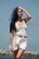 Woman model at the beach in bright sunlight.