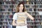 Woman model college student with books at library holds bunch ofWoman model college student with books at library holds bunch book