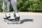 Woman with modern inline roller skates in city park