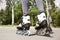 Woman with modern inline roller skates in city park