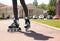 Woman with modern inline roller skates in city park