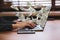 Woman with modern laptop and flying dollar banknotes at table. People make money online