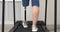 A woman with a modern robotic prosthetic leg is working out in the gym. Physiotherapy rehabilitation that allows a