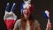 A woman with a mohawk on her head in the color of the French flag supports her sports team. Football fan at the stadium