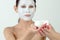 Woman moisturizing face