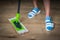 Woman with mop mopping wooden laminate floor