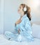 Woman, morning and headphones for meditation on bed while listening to music or podcast while breathing for chakra