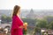 Woman in morning standing on terrace overlooking city