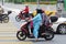 Woman on motorbike with her pillion riders