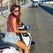 Woman on a motorbike outdoor summer portrait