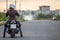 Woman a motorcyclist ready to stard riding on motorbike on asphalt road, copy-space
