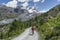 Woman on mountain bike below Rimpfischhornn Zermatt, Switzerland