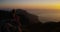 Woman, mountain top and view of sunset, ocean and relax with peace, thinking and memory on hiking adventure. Girl, hill