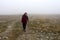 Woman on the mountains meadow in the fog